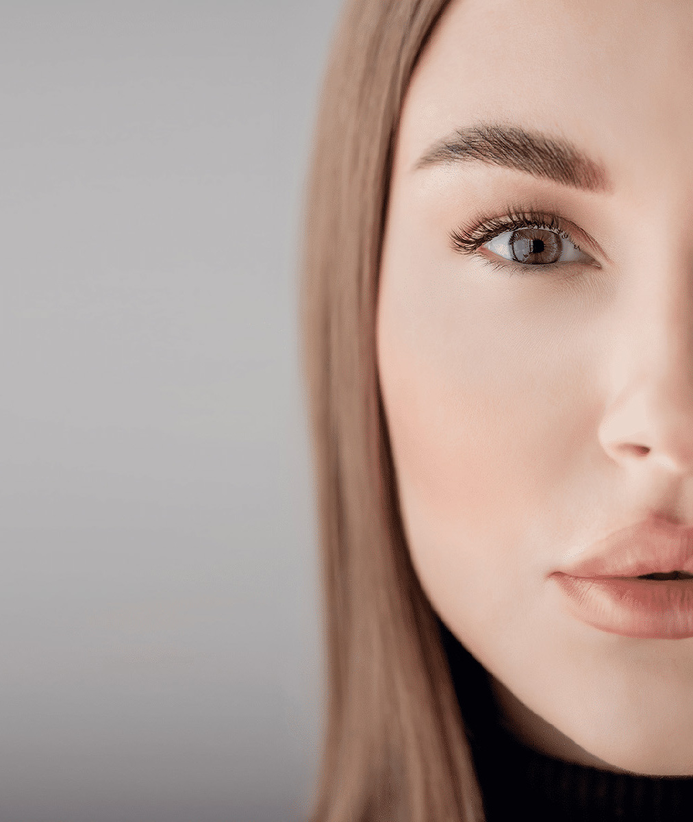 Close-up portrait of a woman with light brown hair and natural makeup.