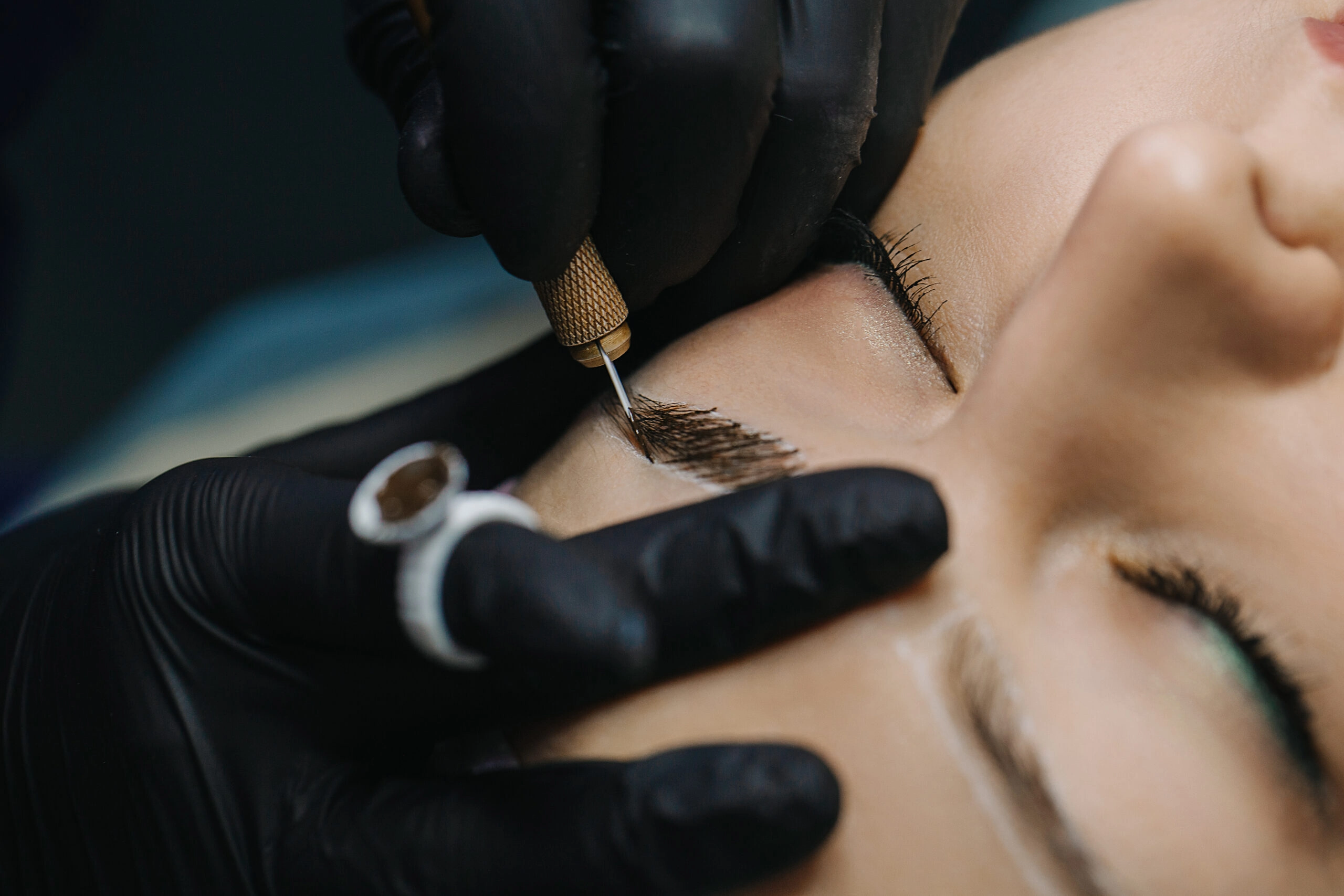Beauty professional performing microblading on a client.